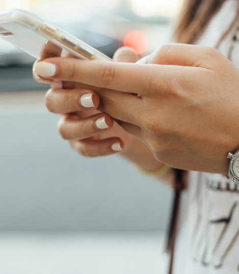 woman holding iPhone during daytime